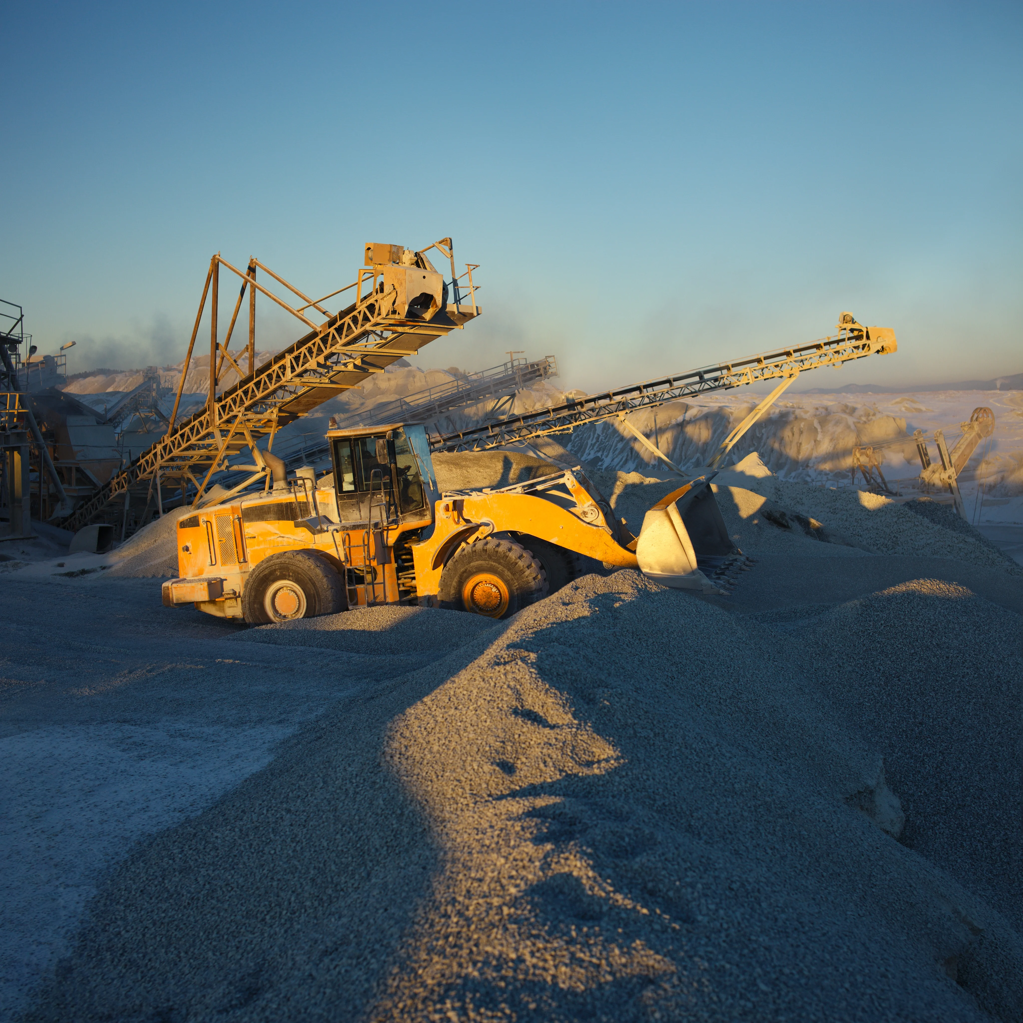 Yellow heavy machinery operating in a quarry